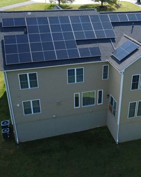 Drone view of a home with a new rooftop solar system