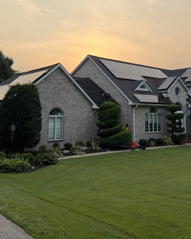 EY Energy Solutions crew finishing a residential install at sunset