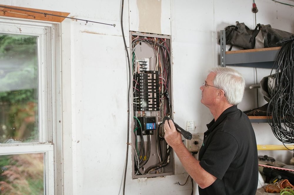 Electrician inspecting a residential main electrical panel